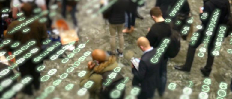 Mobile security. Numbers overlaid on a photograph of people standing and looking down at their phones.