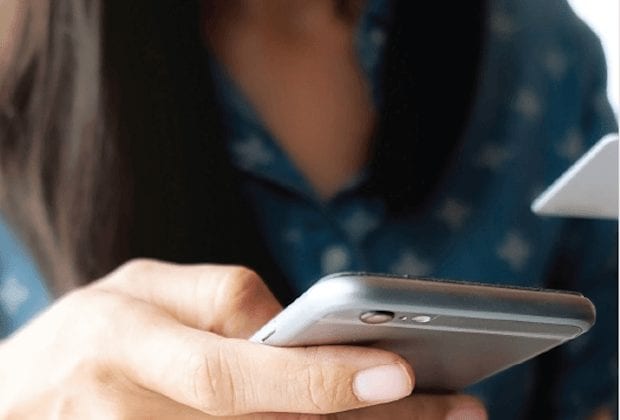 A close up of a hand holding a smartphone.